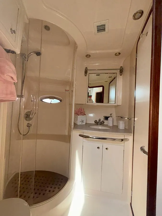 Slide: The Image of 2002 Sea Ray 480 Motor Yacht bathroom with shower, vanity, and mirror. - 27