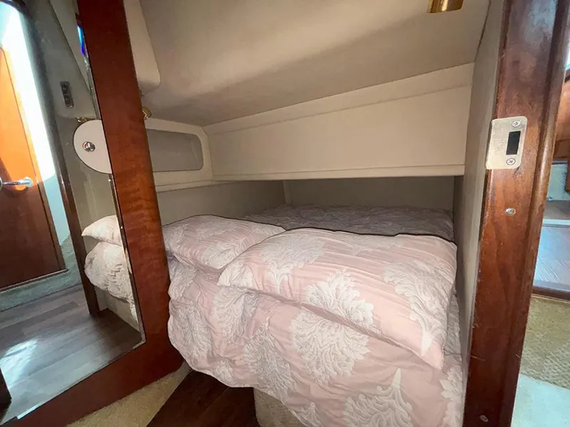 Slide: The Image of Cozy bedroom in 2002 Sea Ray 480 Motor Yacht with pink bedding and wooden accents. - 28