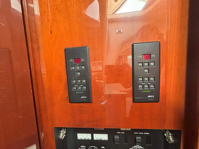 Slide: The Image of Control panel of a 2002 Sea Ray 480 Motor Yacht with digital displays and buttons. - 30