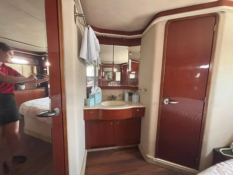 Slide: The Image of 2002 Sea Ray 480 Motor Yacht interior with vanity and wood accents. - 32