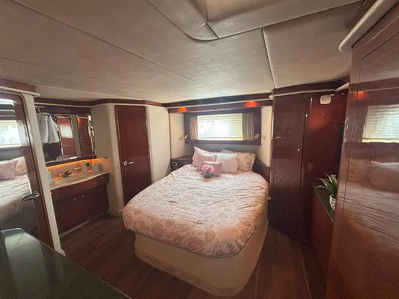 Slide: The Image of Luxurious bedroom interior of 2002 Sea Ray 480 Motor Yacht with elegant wood finishes. - 34
