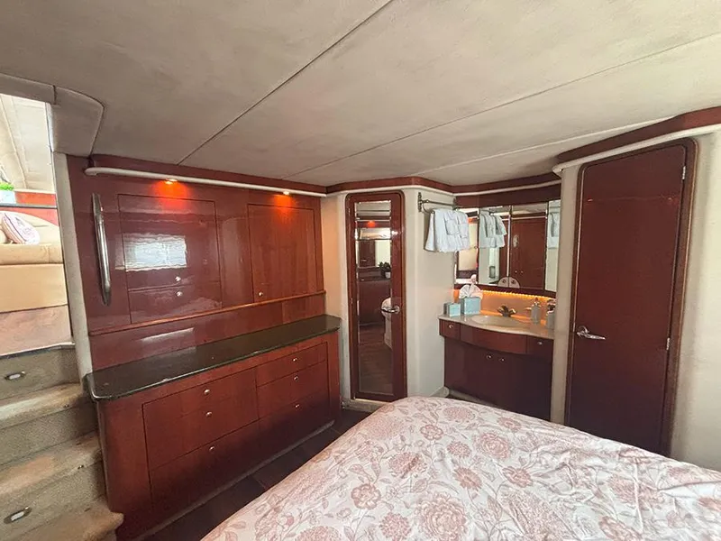 Slide: The Image of Luxurious 2002 Sea Ray 480 Motor Yacht interior with elegant wood cabinetry and cozy bedroom. - 38