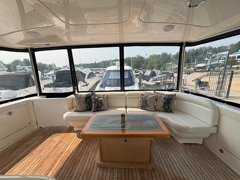 Slide: The Image of Luxurious interior of 2002 Sea Ray 480 Motor Yacht with plush seating and wooden table. - 41