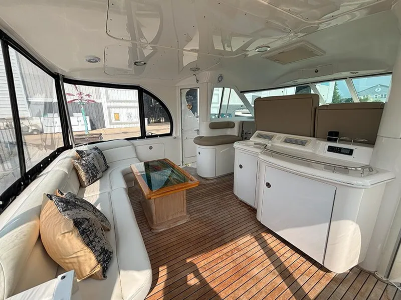Slide: The Image of Interior of 2002 Sea Ray 480 Motor Yacht with elegant seating and wooden flooring. - 42
