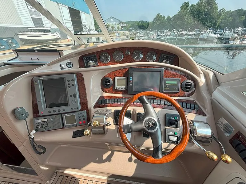 Slide: The Image of Helm of 2002 Sea Ray 480 Motor Yacht with navigation instruments and wooden steering wheel. - 45