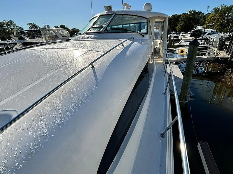 Slide: The Image of 2002 Sea Ray 480 Motor Yacht docked, showcasing sleek design and glossy finish. - 5
