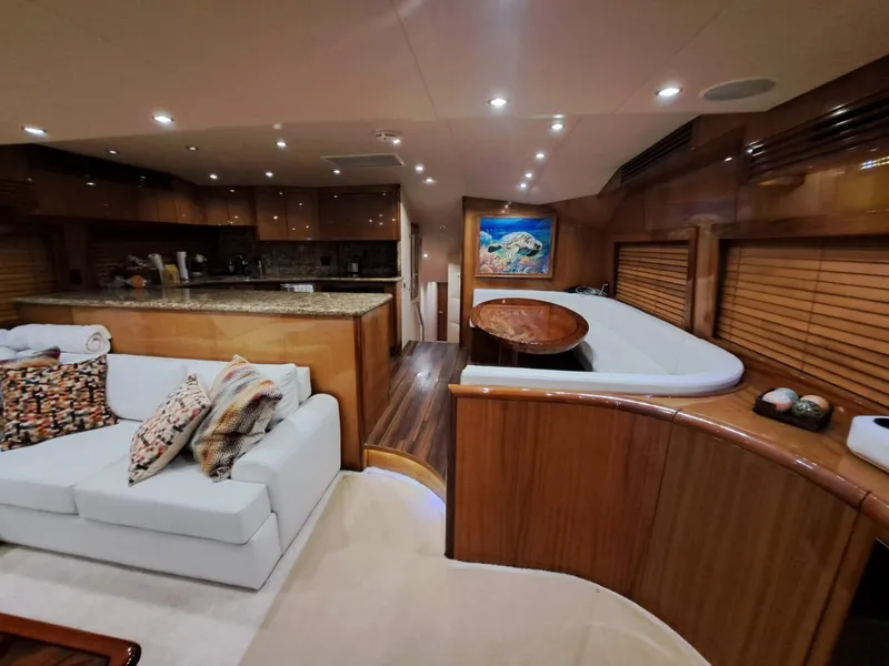 Slide: The Image of Luxurious interior of 2006 Hatteras 68 Convertible yacht with modern kitchen and cozy seating area. - 13