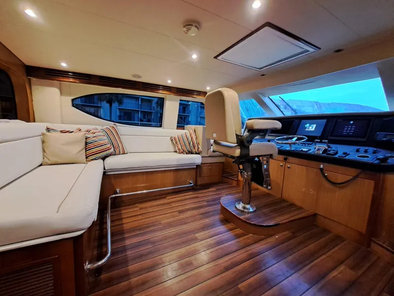 Slide: The Image of Luxurious interior of 2006 Hatteras 68 Convertible yacht with plush seating and modern helm. - 21