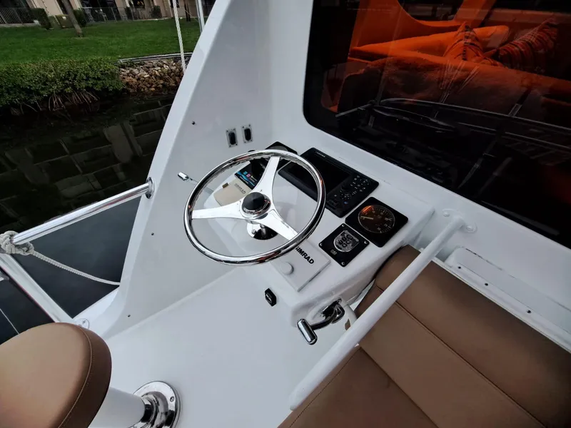 Slide: The Image of Steering console of 2006 Hatteras 68 Convertible yacht with modern controls. - 43