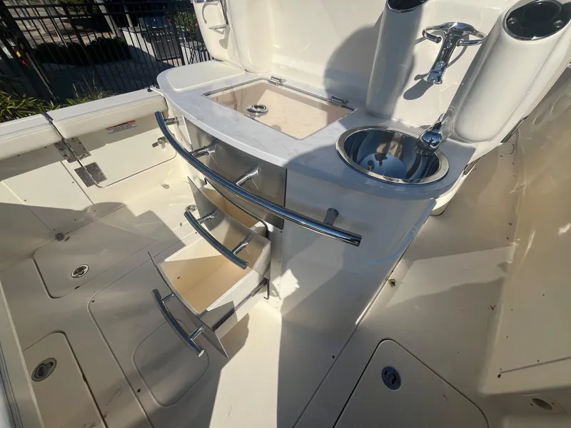 Slide: The Image of 2025 Scout 277 LXF boat interior with sink and storage area. - 10
