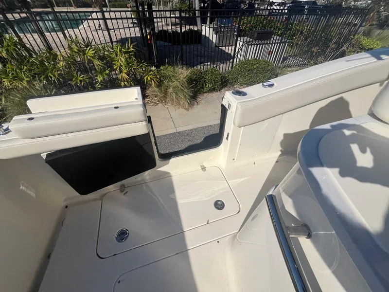 Slide: The Image of 2025 Scout 277 LXF boat interior with open hatch and seating area. - 6