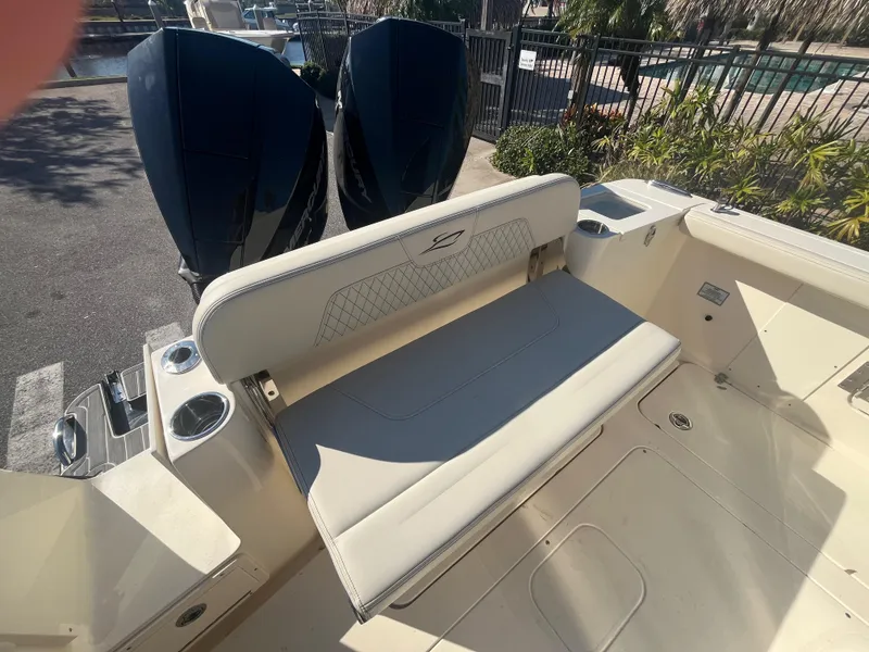 Slide: The Image of 2025 Scout 277 LXF boat with dual engines and cushioned seating. - 8