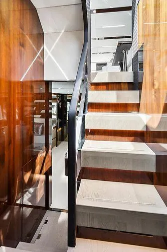 Slide: The Image of Interior staircase of 2021 Fairline Squadron 68 yacht, featuring sleek wood and modern design. - 29