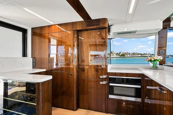 Slide: The Image of Luxurious kitchen interior of 2021 Fairline Squadron 68 yacht with wood finishes and ocean view. - 40