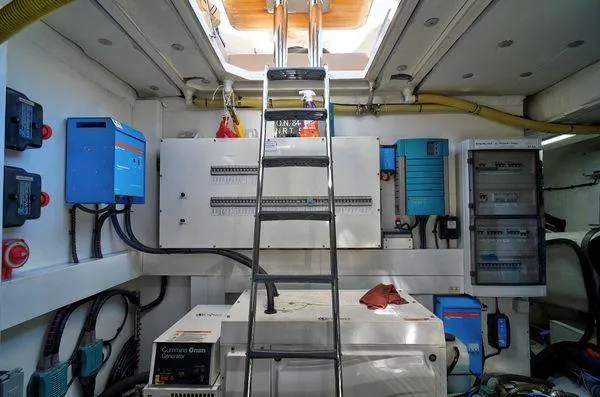 Slide: The Image of Engine room of 2021 Fairline Squadron 68 yacht with electrical equipment and ladder. - 9