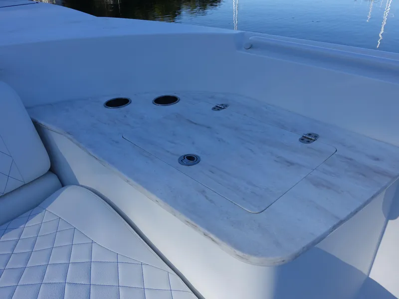 Slide: The Image of 2014 Cigarette 42 Huntress boat interior with white seating and table. - 14