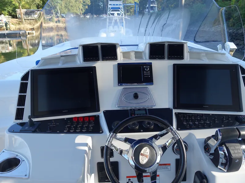 Slide: The Image of 2014 Cigarette 42 Huntress boat dashboard with dual screens and steering wheel. - 16