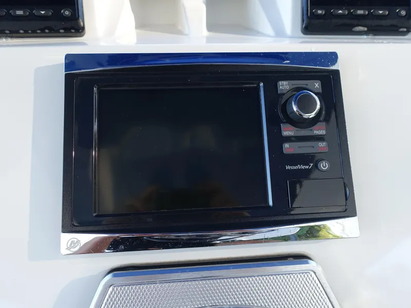 Slide: The Image of Control panel of a 2014 Cigarette 42 Huntress boat with display screen and buttons. - 18
