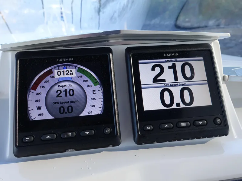 Slide: The Image of Garmin marine displays on 2014 Cigarette 42 Huntress showing depth and GPS speed. - 19