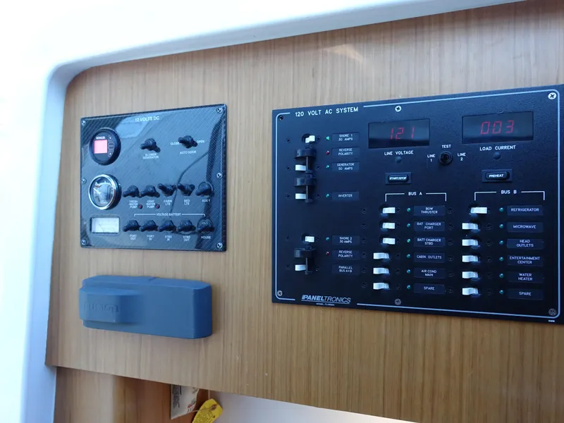 Slide: The Image of Control panel of 2014 Cigarette 42 Huntress boat with electrical switches and gauges. - 23
