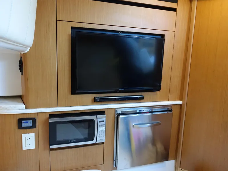 Slide: The Image of 2014 Cigarette 42 Huntress interior with TV, microwave, and mini-fridge. - 24