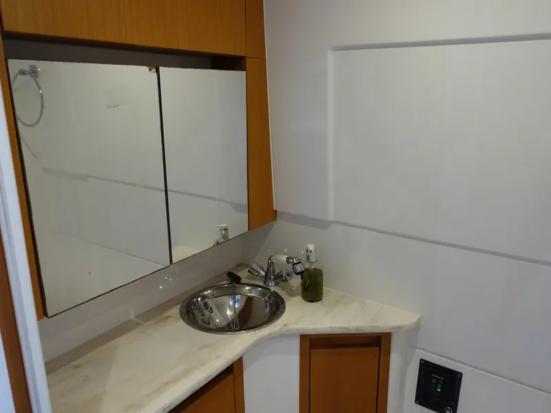 Slide: The Image of 2014 Cigarette 42 Huntress bathroom with modern sink and mirror. - 28