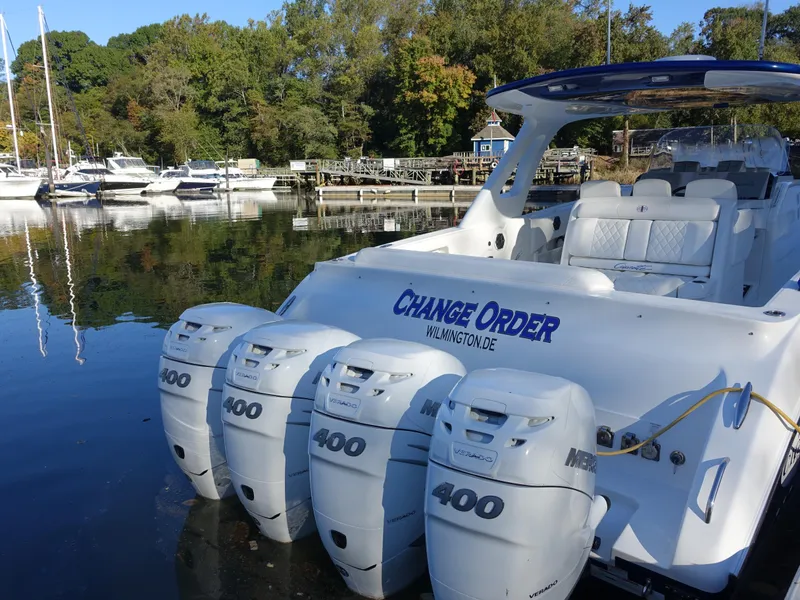 Slide: The Image of 2014 Cigarette 42 Huntress boat with four powerful engines docked at a marina. - 6