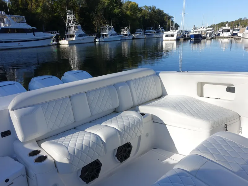 Slide: The Image of 2014 Cigarette 42 Huntress boat with luxurious white seating in a marina. - 8