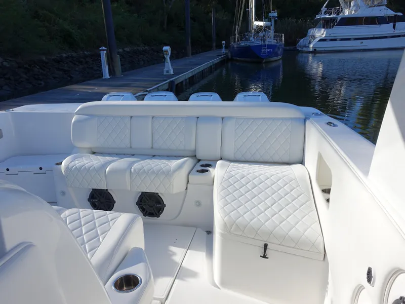 Slide: The Image of 2014 Cigarette 42 Huntress boat with white quilted seating at a marina. - 9