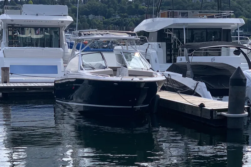 The Image of 2022 Cutwater C-24 DC boat docked at marina, surrounded by other vessels. - 0