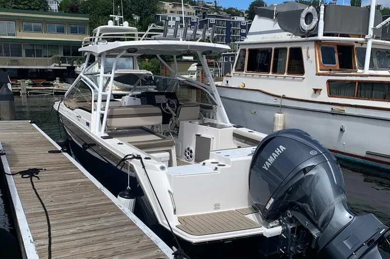 Slide: The Image of 2022 Cutwater C-24 DC boat docked with Yamaha outboard motor. - 1