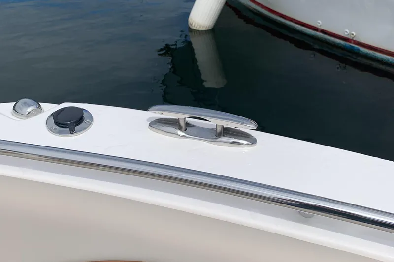 Slide: The Image of 2022 Cutwater C-24 DC boat cleat and railing detail on calm water. - 19
