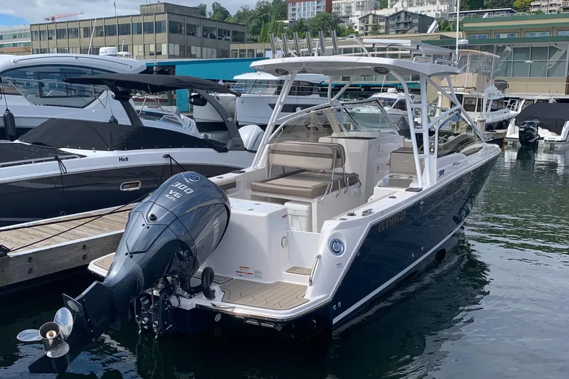 Slide: The Image of 2022 Cutwater C-24 DC boat docked at marina with outboard motor. - 2