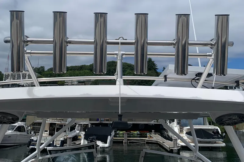 Slide: The Image of Cutwater C-24 DC 2022 boat with stainless steel rod holders at a marina. - 21