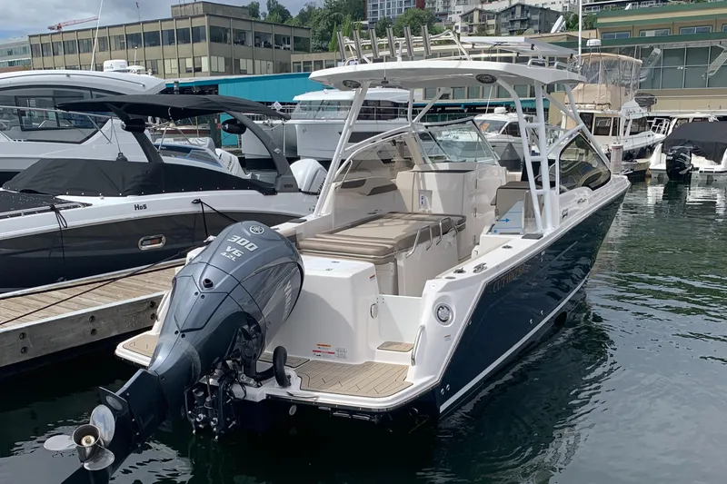 Slide: The Image of 2022 Cutwater C-24 DC boat docked at marina with Yamaha outboard motor. - 23