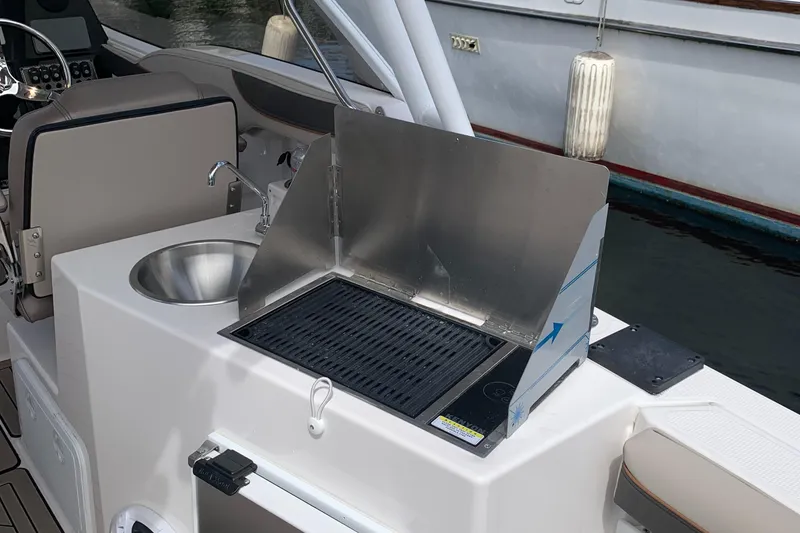 Slide: The Image of 2022 Cutwater C-24 DC boat with onboard grill and sink setup. - 5