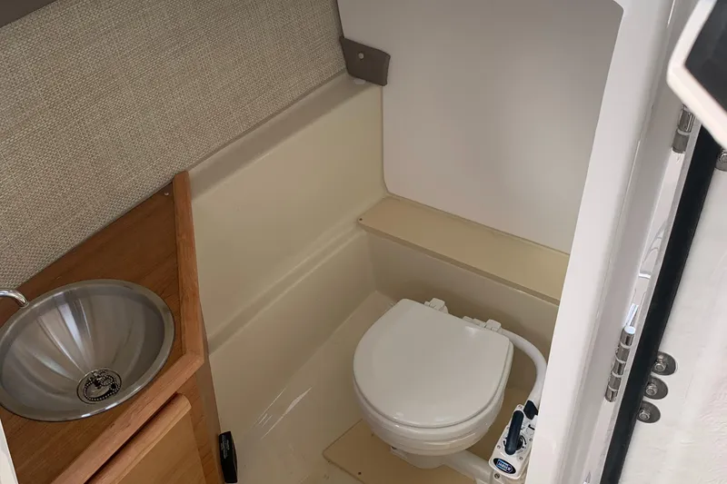 Slide: The Image of 2022 Cutwater C-24 DC boat bathroom with sink and toilet. - 7