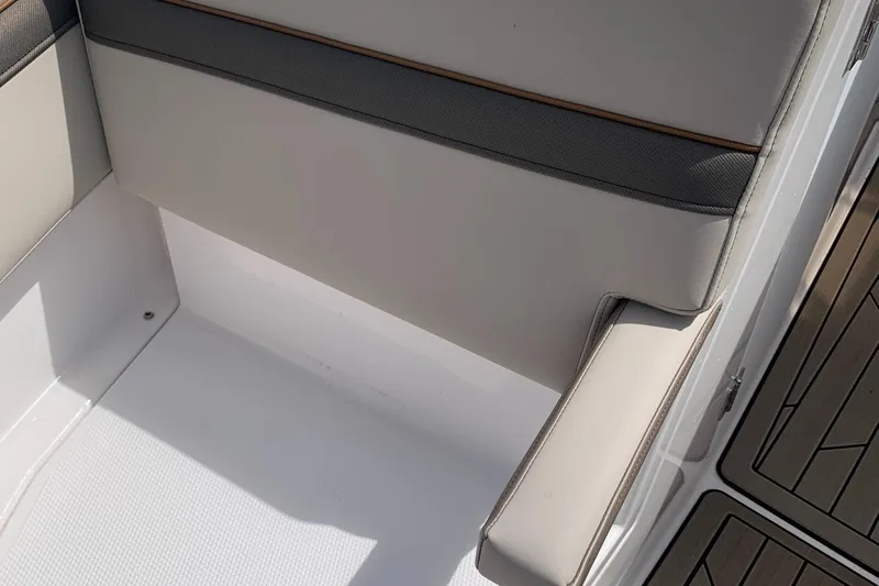 Slide: The Image of Cutwater C-24 DC 2022 boat interior seating with gray and white upholstery. - 9