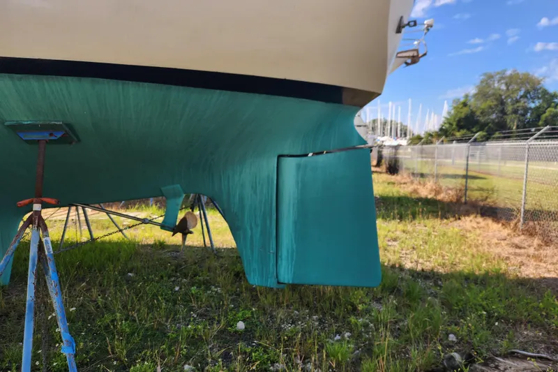 Slide: The Image of 1979 Morgan 45 Ketch sailboat hull on stands, outdoor storage. - 11