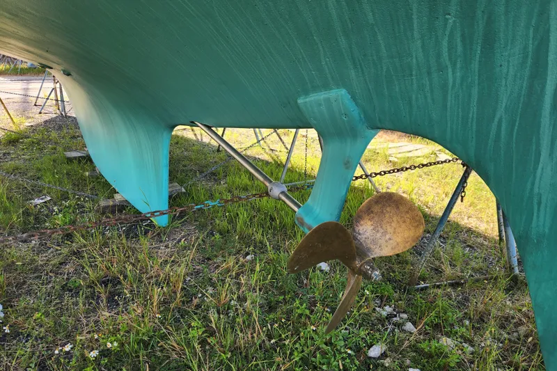 Slide: The Image of 1979 Morgan 45 Ketch sailboat hull and propeller on land. - 12