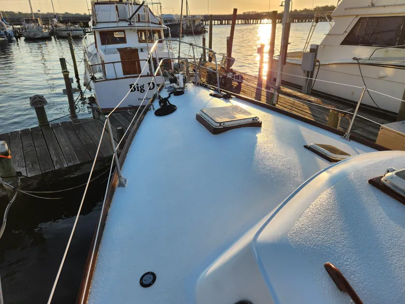 Slide: The Image of 1979 Morgan 45 Ketch sailboat docked at sunset in a marina. - 15
