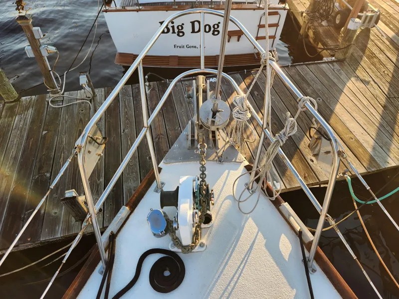 Slide: The Image of 1979 Morgan 45 Ketch sailboat docked, featuring deck and rigging details. - 19