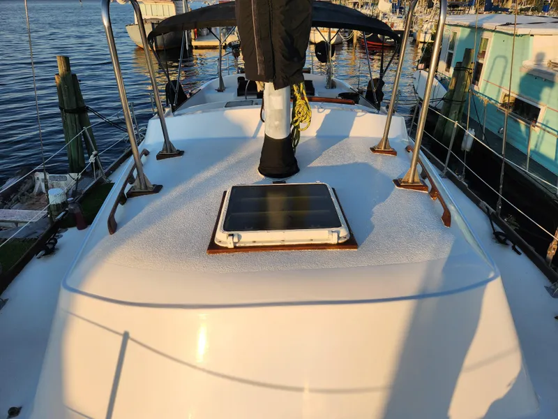 Slide: The Image of 1979 Morgan 45 Ketch sailboat deck with solar panel, docked at marina. - 20