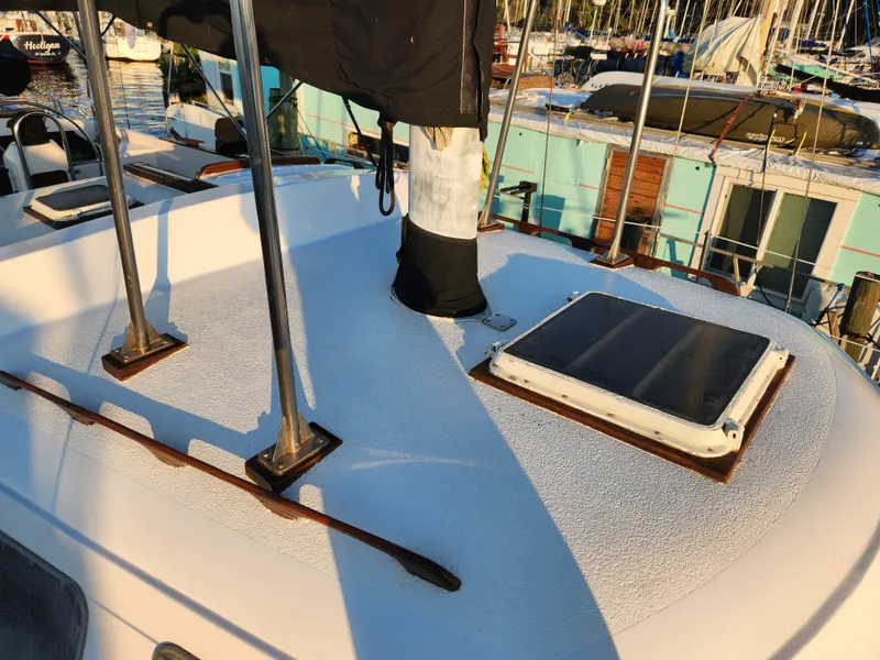 Slide: The Image of 1979 Morgan 45 Ketch deck with hatches and rigging in a marina setting. - 24