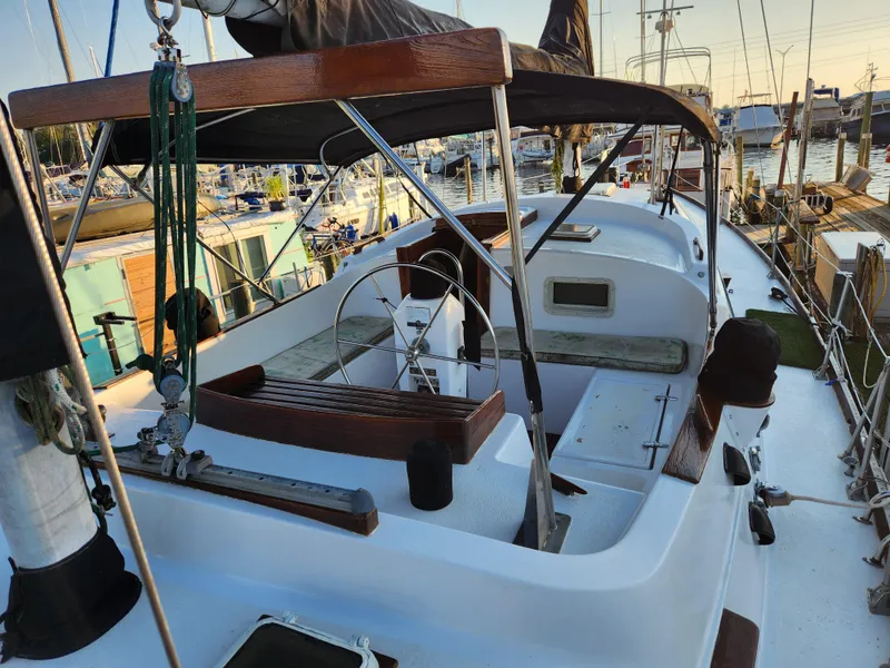 Slide: The Image of 1979 Morgan 45 Ketch sailboat docked at marina, featuring spacious cockpit and classic design. - 27
