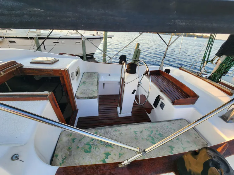 Slide: The Image of 1979 Morgan 45 Ketch sailboat cockpit with wooden accents and steering wheel. - 31
