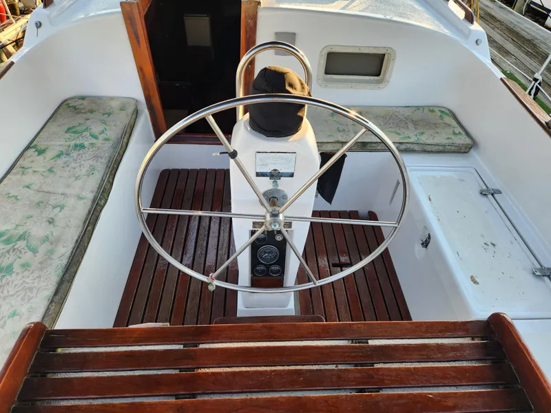 Slide: The Image of 1979 Morgan 45 Ketch cockpit with wooden seating and steering wheel. - 33