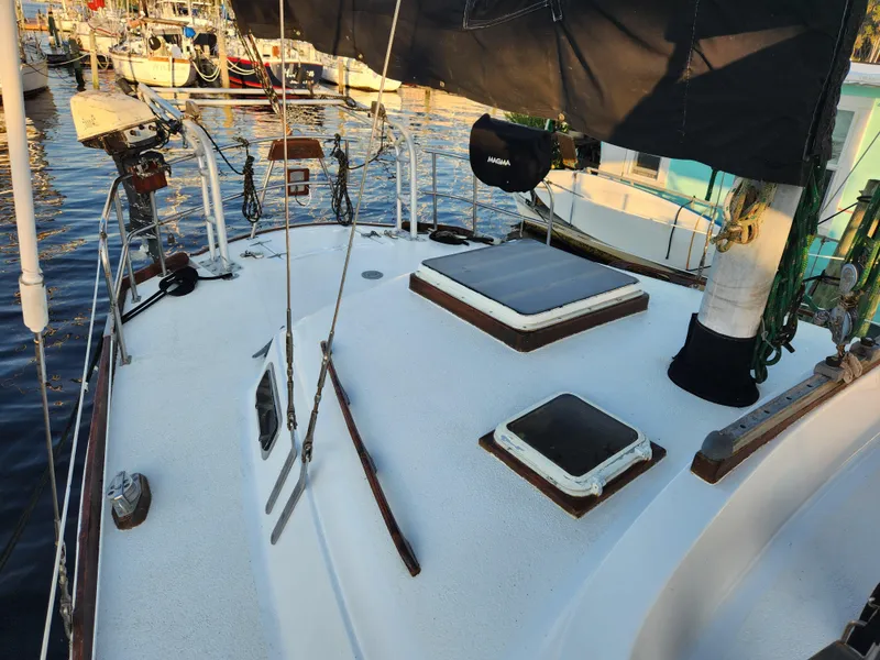 Slide: The Image of 1979 Morgan 45 Ketch sailboat deck with hatches, docked in a marina. - 39