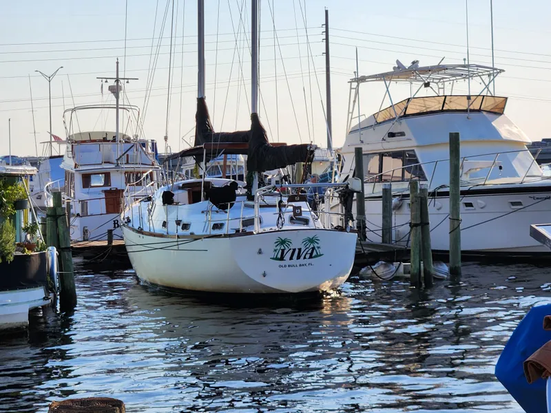 Slide: The Image of 1979 Morgan 45 Ketch sailboat docked at a marina, surrounded by other boats. - 4
