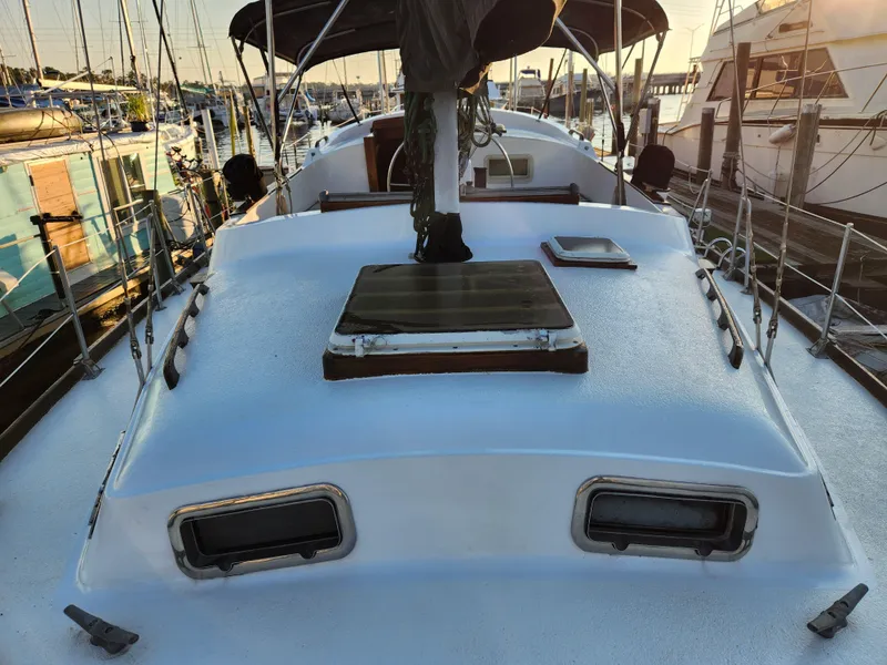 Slide: The Image of 1979 Morgan 45 Ketch sailboat docked at marina, featuring deck and cabin details. - 42